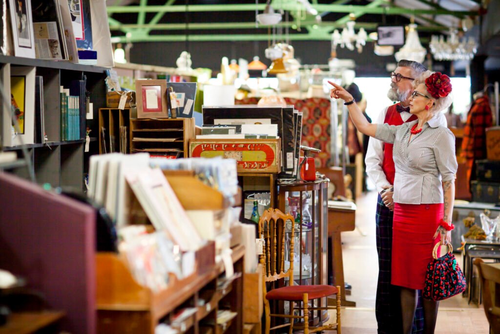 quirky vintage couple shopping together in antiques emporium